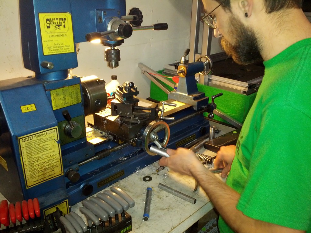 Austin checks his lathe work.