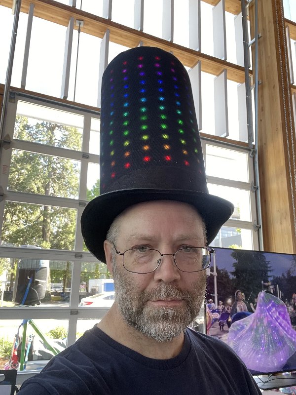 Sam with a tall top hat with a grid of RGB leds showing a pattern